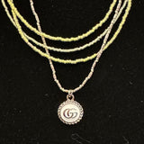 GG Pendant on Multi-Strand Pale Green Necklace